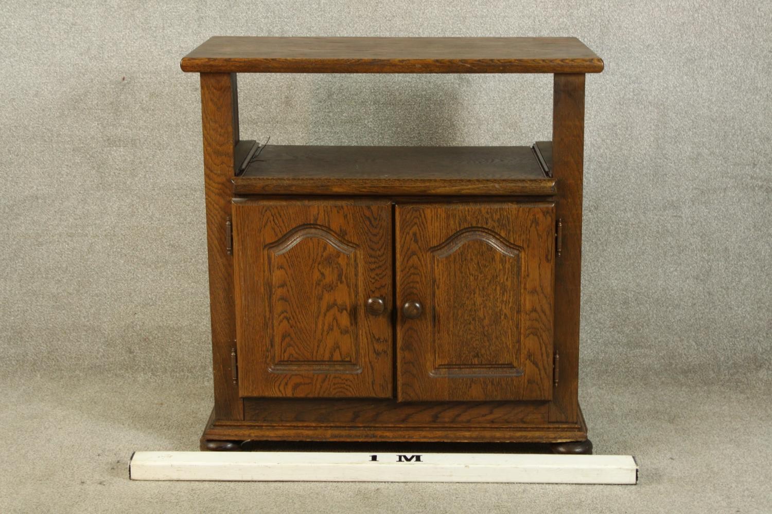 A contemporary oak twin door television cabinet raised on bun feet. H.83 W.79 D.42cm. - Image 2 of 5