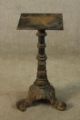 A 19th century cast iron table base, the turned central column raised on three scroll feet. H.69cm.