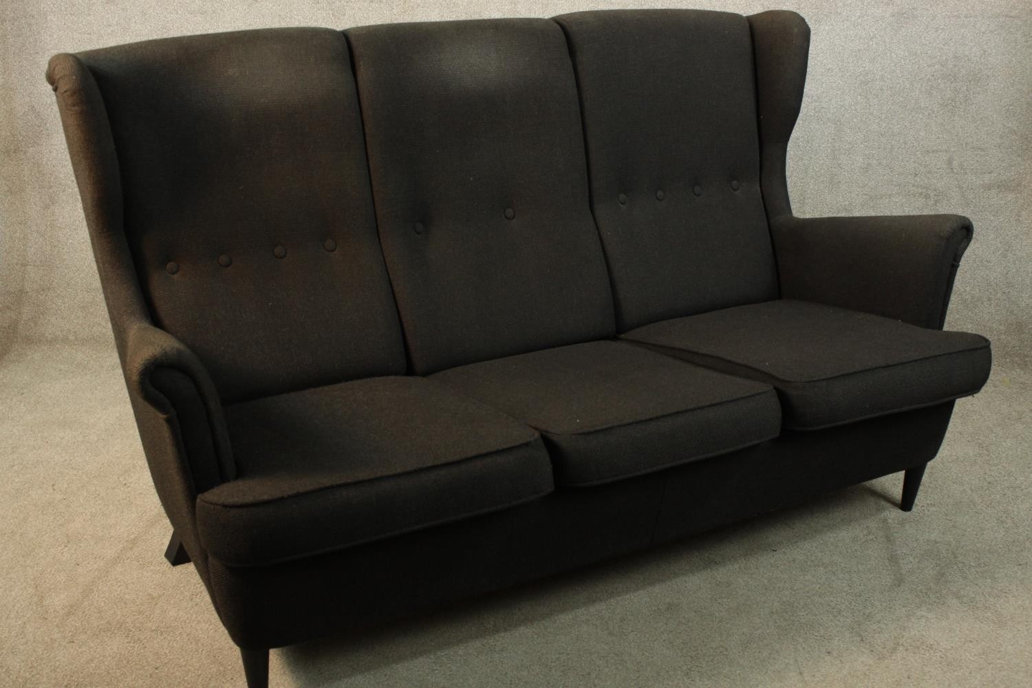 A contemporary black upholstered three person button back and scroll arm sofa raised on tapering - Image 4 of 4