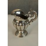 A 19th century Swedish hallmarked silver jug, with cast acanthus leaf scroll work handle, the half