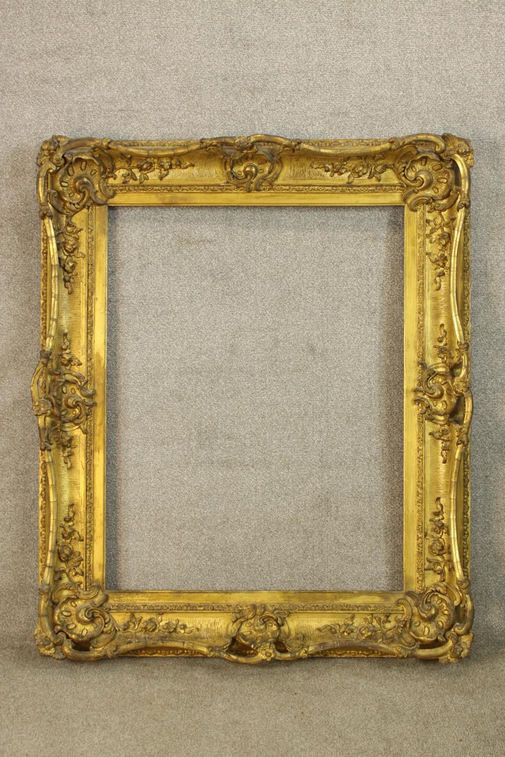 A 19th/ early 20th century Rococo style rectangular gilt frame. H.120 W.100cm.