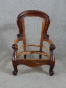 A 19th century mahogany framed child's open arm chair raised on cabriole supports terminating in