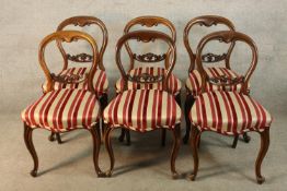 A set of six Victorian mahogany framed balloon back dining chairs with red and white stuff over