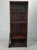 A contemporary floor standing stained teak open bookshelf raised on plinth base. H.203 W.76 D.40cm