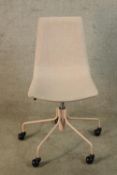 A contemporary pink canvas office swivel chair raised on five splayed supports terminating plastic
