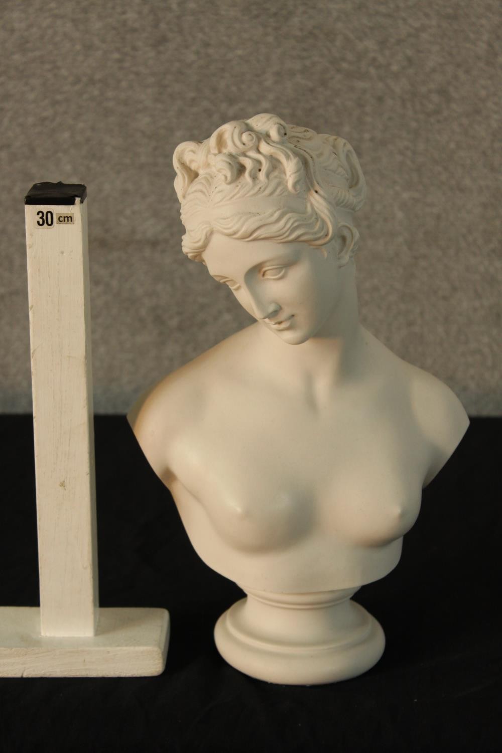 An early 20th century painted porcelain bust of a semi clad classical lady raised on turned socle - Image 2 of 4