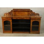 A 19th century walnut twin pedestal sideboard, each pedestal with single glazed door raised on