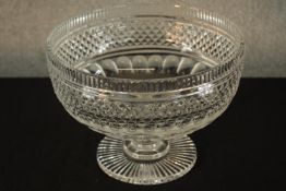 A 19th century, possibly Irish, diamond cut glass footed bowl raised on fluted circular foot. H.20