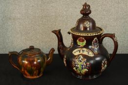 An early 20th century Bargeware style teapot and cover together with a smaller 20th century 20th