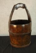 An early 20th century stained oak coopered wooden bucket with carrying handle. H.58cm.