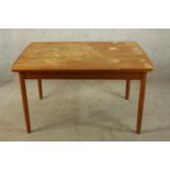 A mid 20th century Danish style teak draw leaf dining table raised on tapering supports. H.72 W.