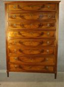 A late 19th/early 20th century French mahogany chest of eight long drawers with brass lion mask