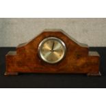 An Art Deco walnut cased eight day mantle clock raised on shaped bracket feet. H.18cm.