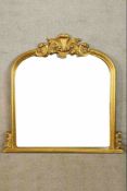 A 20th century Italian style gilt overmantel arch topped overmantel mirror with carved decoration.