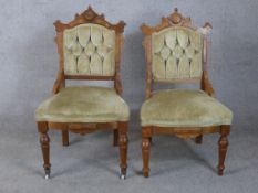 A pair of 19th century Gothic Revival walnut framed button back chairs raised on turned supports