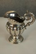 A 19th century Swedish hallmarked silver jug, with cast acanthus leaf scroll work handle, the half