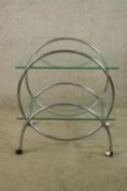 A mid century glass and chrome two shelf modernist trolley raised on plastic wheels. H.73 W.67 D.