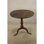 A 19th century mahogany tilt top table, the turned central column raised on three slayed supports