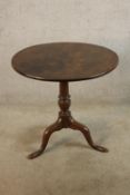 A 19th century mahogany tilt top table, the turned central column raised on three slayed supports