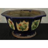 A 20th century Chinese pottery octagonal shaped garden planter decorated with panels of flowers