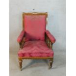 A 19th century Gothic Revival Puginesque low nursing chair raised on fluted tapering supports