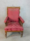 A 19th century Gothic Revival Puginesque low nursing chair raised on fluted tapering supports