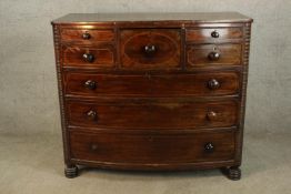 A 19th century inlaid mahogany Scotch style chest of drawers with turned knop handles, carved