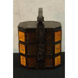 A 20th century Chinese carved lacquered three section food box with carrying handle. H.47 W.34 D.
