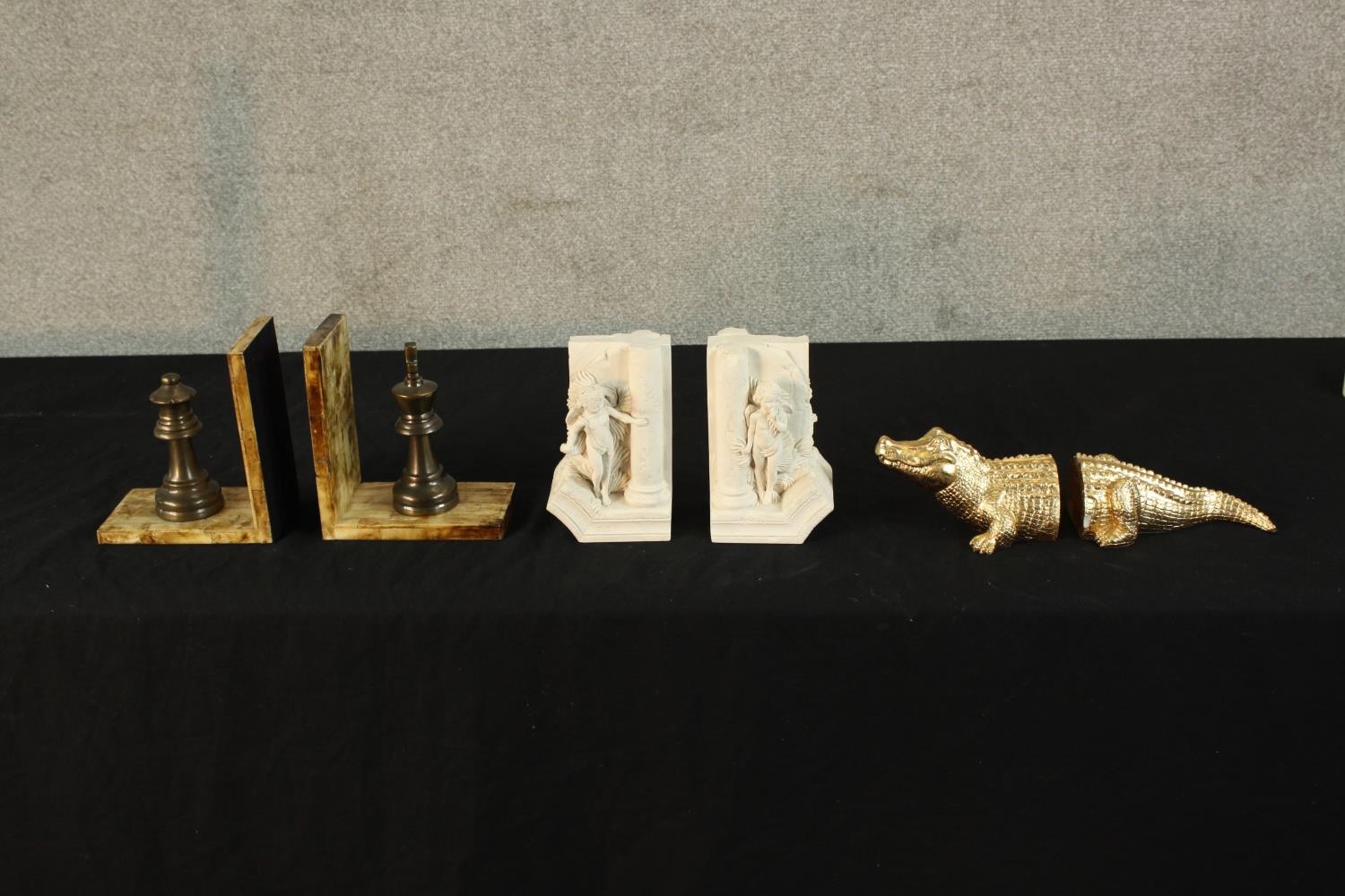 Three pairs of 20th century bookends to include bookends a king and queen chess piece mounted on