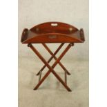 A 20th century mahogany folding butlers tray on 'X' shaped stand. H.69 W.86 D.66cm.