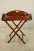 A 20th century mahogany folding butlers tray on 'X' shaped stand. H.69 W.86 D.66cm.