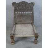 A late 19th century carved hardwood, possibly Junepeus wood low chair from north west Pakistan