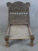 A late 19th century carved hardwood, possibly Junepeus wood low chair from north west Pakistan