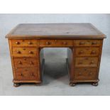A Victorian mahogany and leather inset twin pedestal writing desk with turned handles raised on