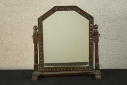 An early 20th century carved oak framed dressing table mirror raised on turned supports. H.59 W.53cm