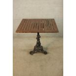 A 19th/early 20th century painted cast iron table base the central dolphin column raised on three