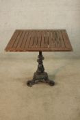 A 19th/early 20th century painted cast iron table base the central dolphin column raised on three