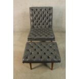 A mid 20th century Baxton Studio buttoned grey leather chair and matching footstool raised on