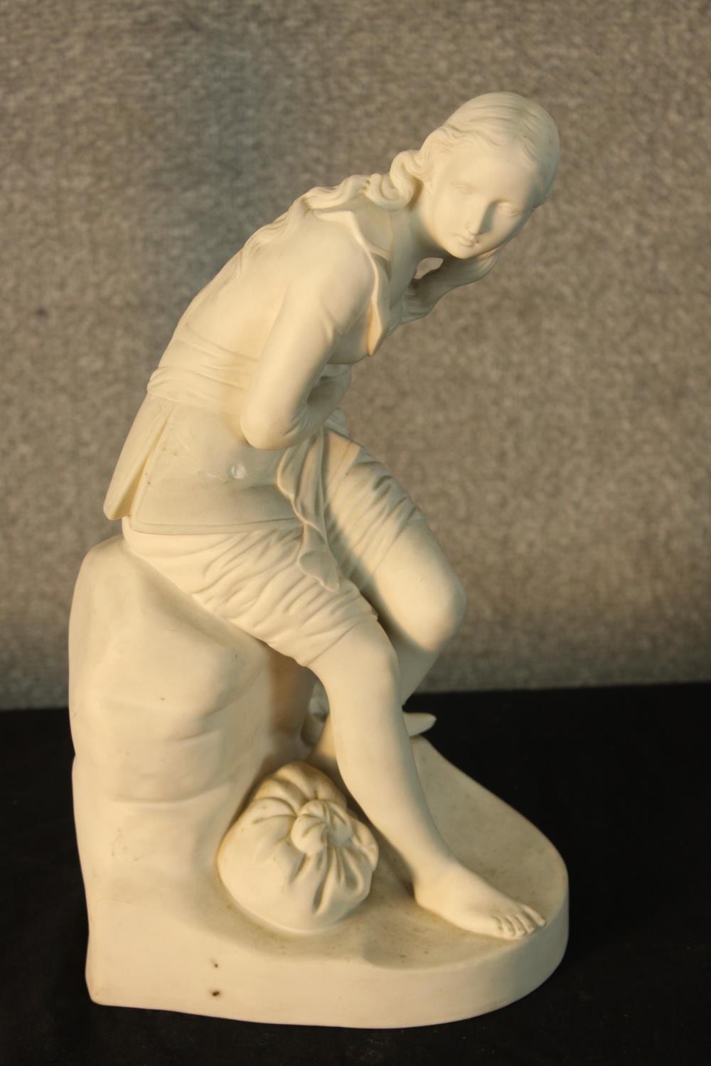 A 19th/early 20th century Parianware figure of a lady sitting on a rock with a sack at her feet, - Image 3 of 3