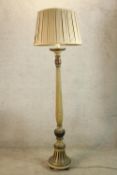 An early 20th century Italian style painted hardwood standard lamp raised on three bun feet. H.