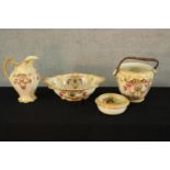 A late 19th century blush ivory pottery toilet set to include jug, bowl and bucket, decorated with