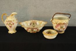 A late 19th century blush ivory pottery toilet set to include jug, bowl and bucket, decorated with