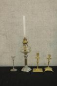 Two 19th century brass candlesticks, together with a silver plated oil lamp base with clear glass