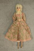 A 19th century clothed female doll with articulated limbs. H.75cm.