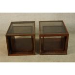 A pair of mahogany framed and smoked glass cube form occasional tables, together with a smaller