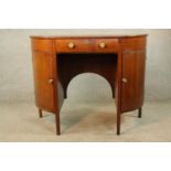 A 19th century mahogany demi lune twin door sideboard with central drawer raised on square