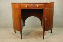 A 19th century mahogany demi lune twin door sideboard with central drawer raised on square