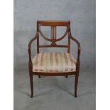 A late 19th/early 20th century mahogany framed open armchair, with stuff over seat raised on