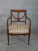 A late 19th/early 20th century mahogany framed open armchair, with stuff over seat raised on