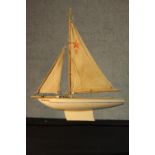 A 20th century painted pond yacht, Endeavor II with canvas sails. H.50 W.40cm.